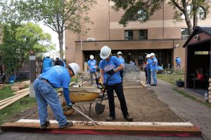 engineers work on widening sidewalks for day of caring