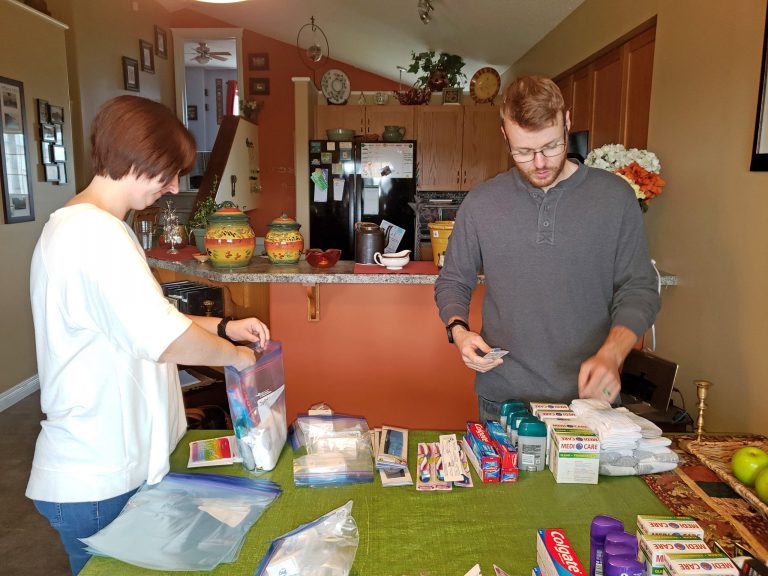 A couple builds hygiene kits for United Way of the Alberta Capital Region's Volunteer At Home donation drive.