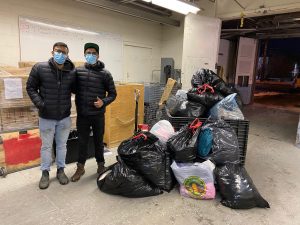 Pranav poses with the winter items that he collected at United Way’s InKind Exchange.