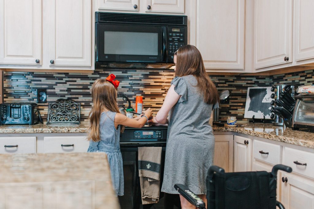 A mother cooks with her daughter