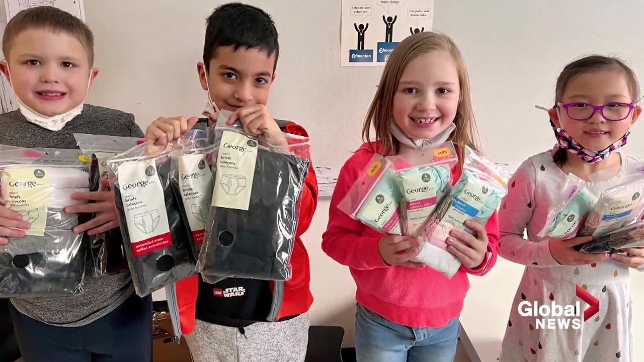 Students hold up collected items for donation