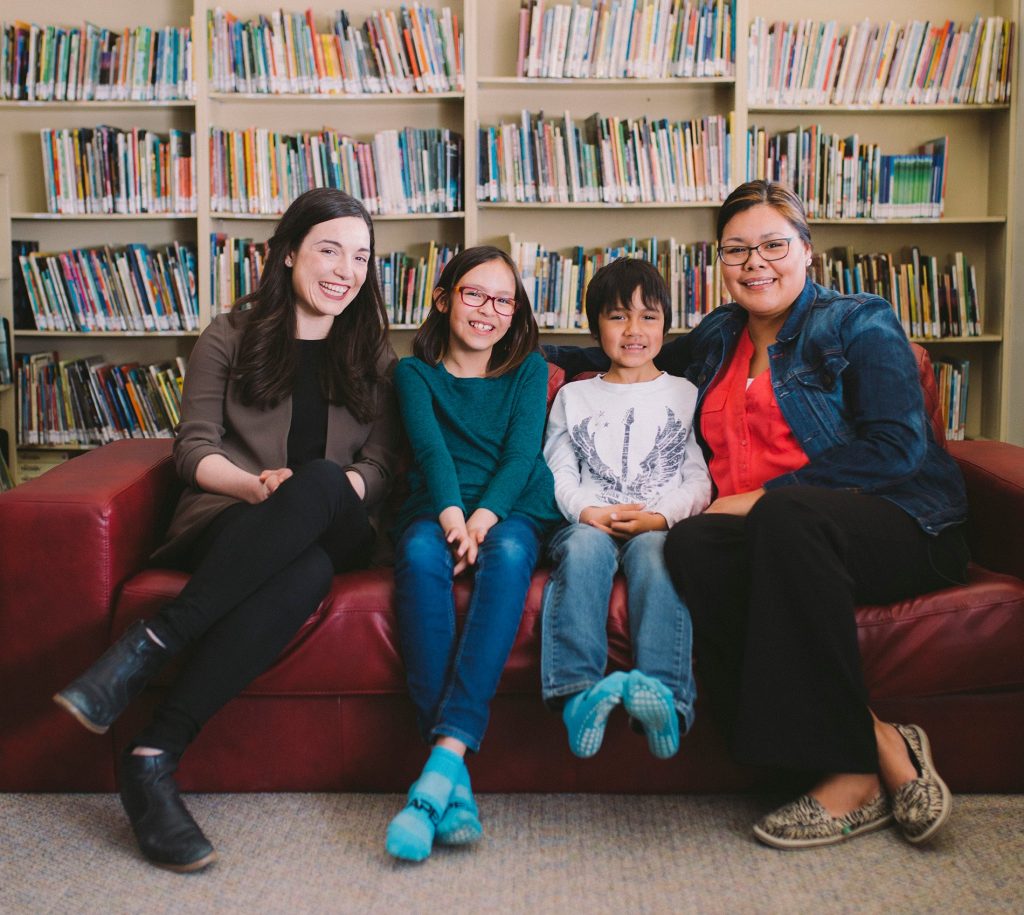 smiling children and parent on couch