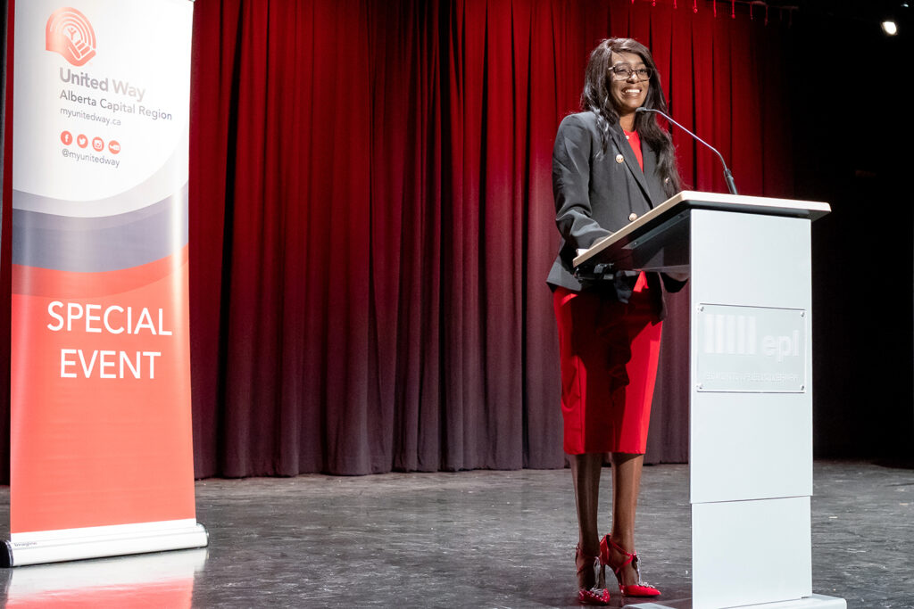 Tsisti Chiwara standing at podium at United Way special event