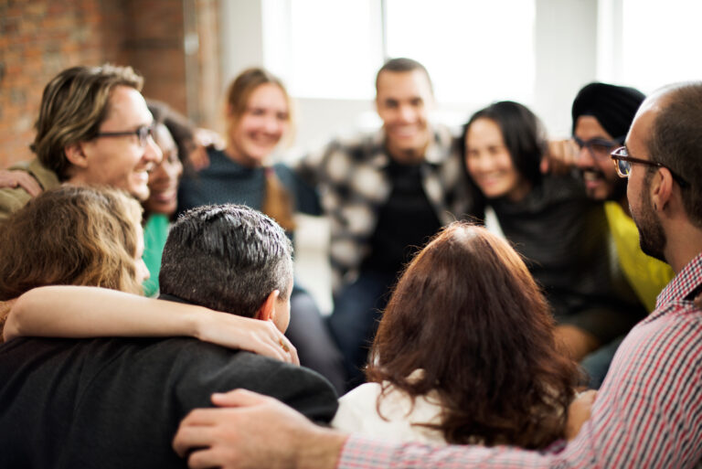 Group of people hugging in a circle