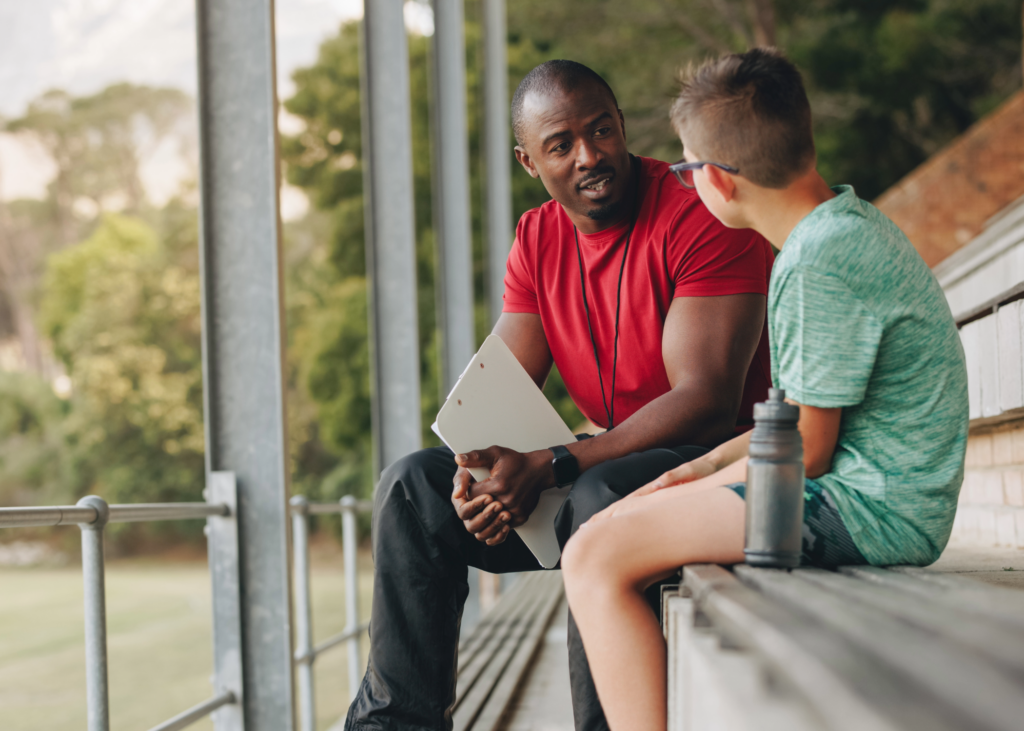 Young Kid being Mentored by Older Man