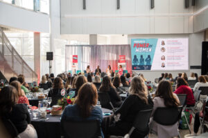 Audience listening to a panel of women speakers at women united's event power of women 2023