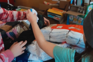 Hazeldean School students in Edmonton sort warm winter wear as part of their Make Your Mark project, made possible through a $1,000 grant from United Way of the Alberta Capital Region.