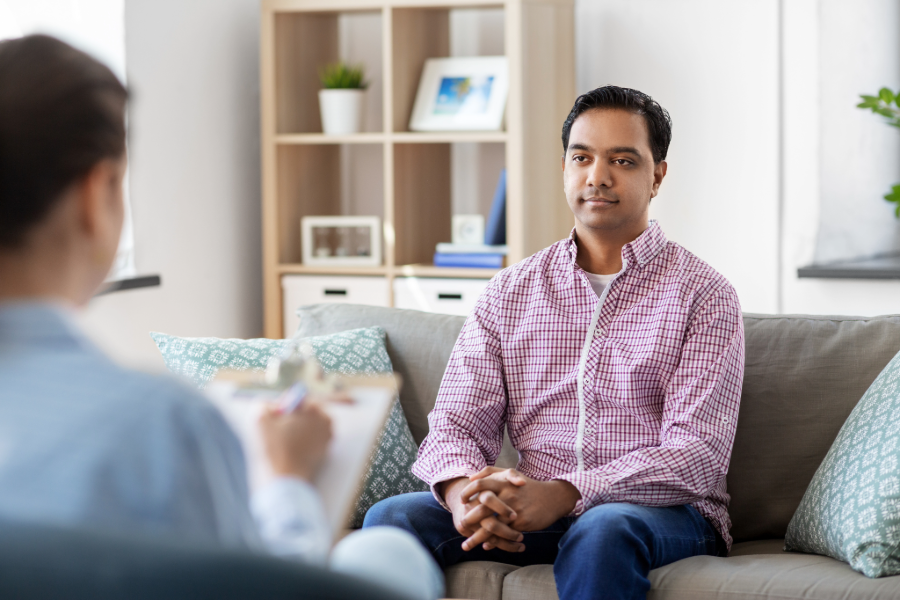 mental health young south asian man patient and woman psychologist