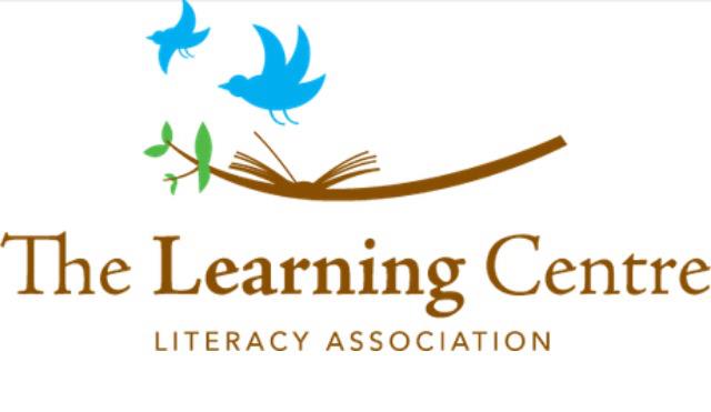 The Learning Centre Literacy Association logo featuring two stylized blue birds in flight above an open brown book with green leaves sprouting from its spine, symbolizing growth, learning, and community support.